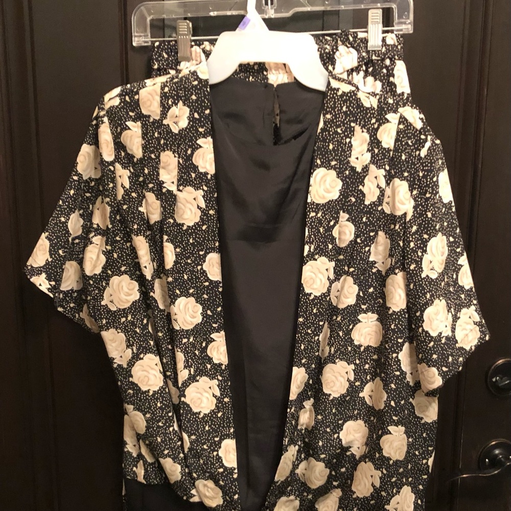 Black and white floral skirt and blouse ensemble.